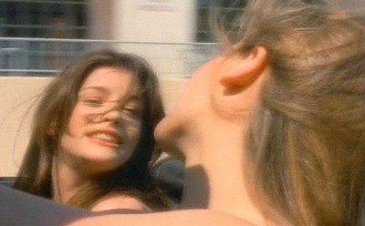 Alicia Silverstone and Liv Taylor singing out loud while driving the car in a still from “Cryin”.