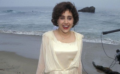 Brittany Murphy dressed in a creamy silk dress at the beach attending the Clueless Malibu Premier circa 1995.