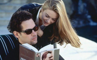 Still from Alicia Silverstone flipping her hair calling for Paul Rudd attention while he is reading a book.